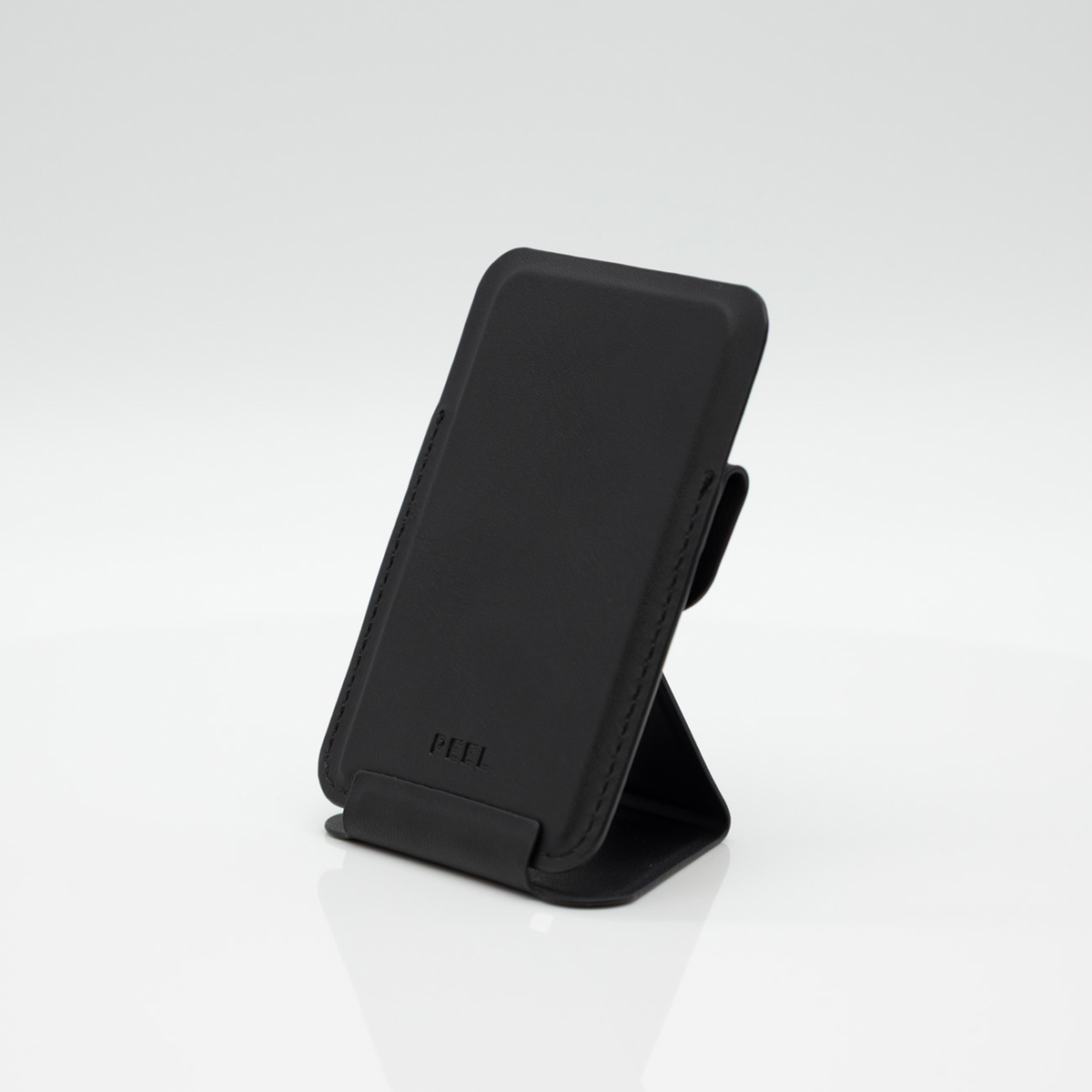 Peel Magnetic Wallet Stand standing upright with the fold-out stand extended